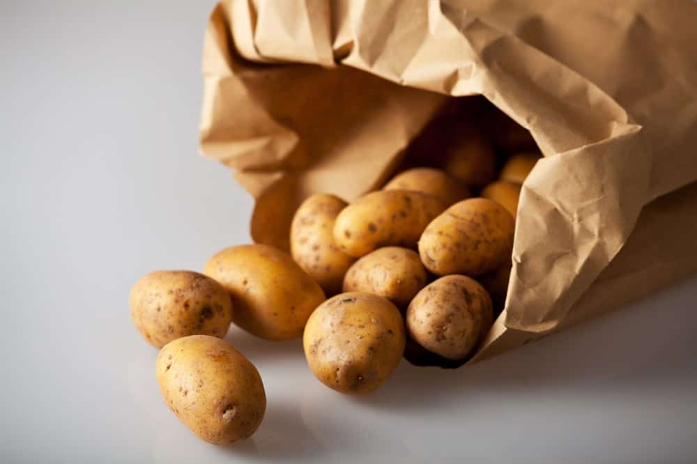 Put potatoes in a paper bag to keep them fresher longer